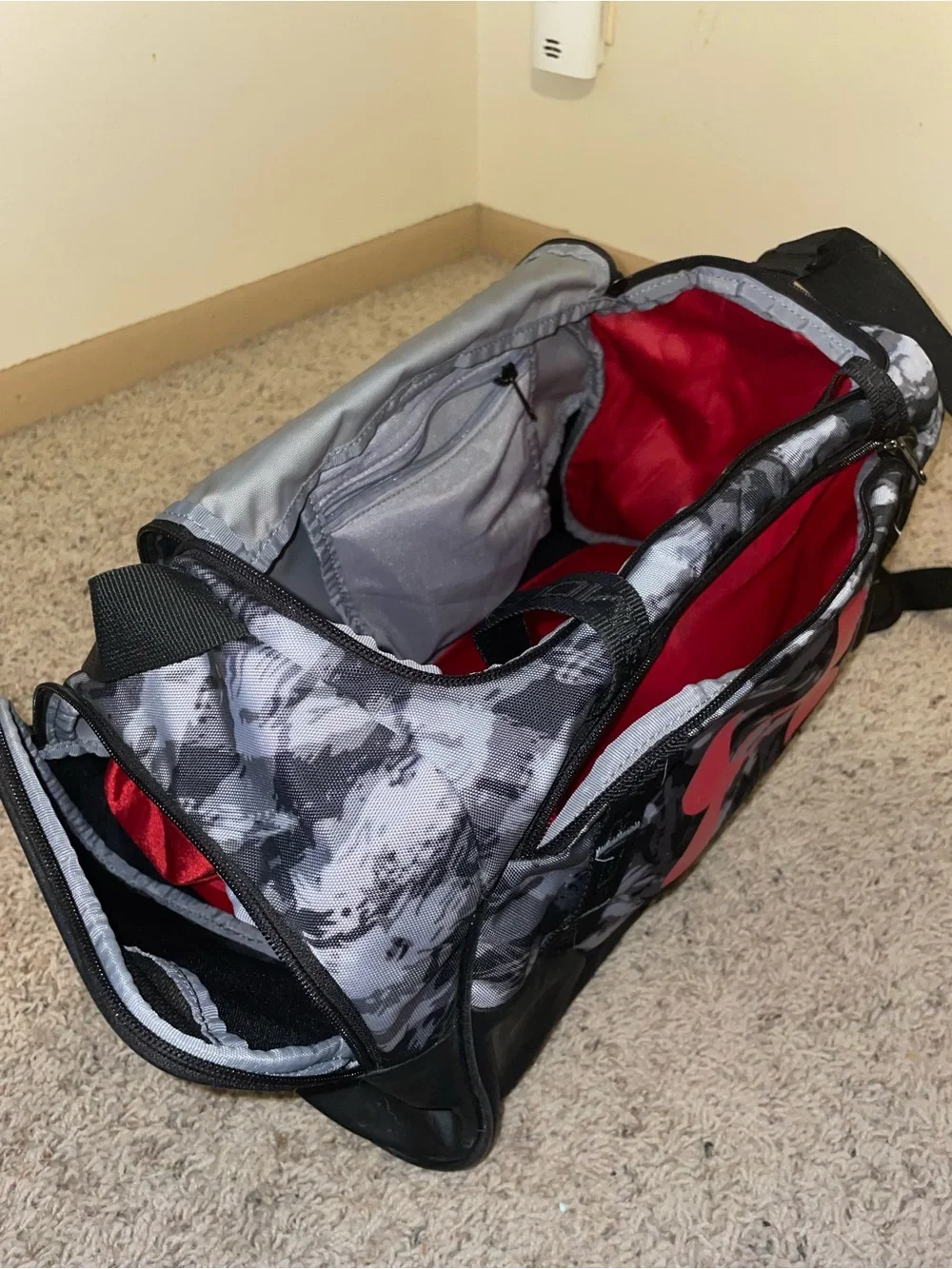 Under Armour Men’s Gray Camo Duffel Bag with Red Logo